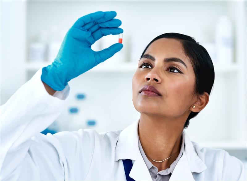 Scientist examining a capsule.
